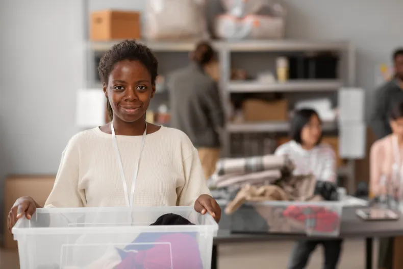 Volunteer sorting donated clothing